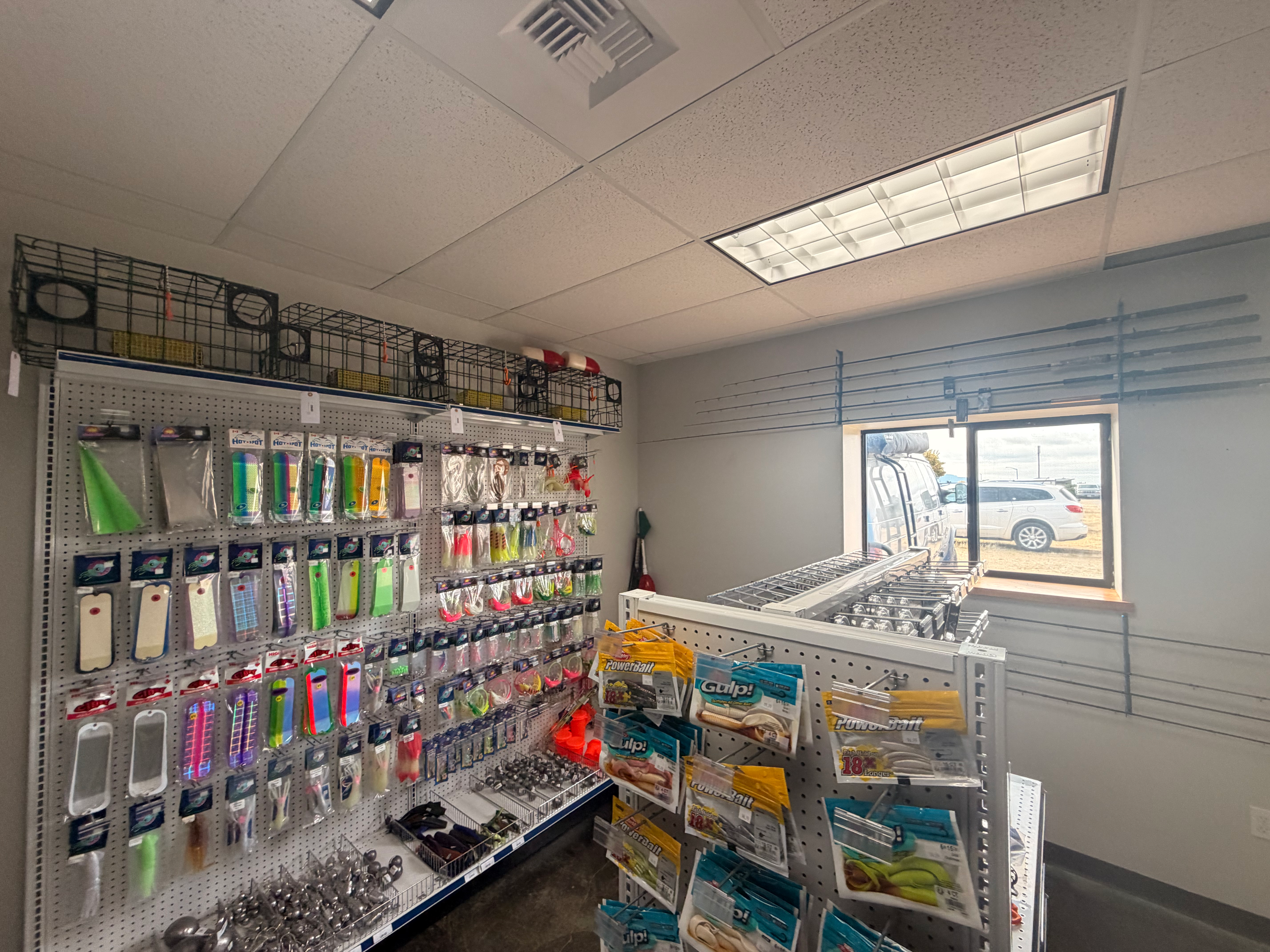 Fishing tackle and bait wall with lures, PowerBait, and crab traps, ESI North Anacortes marine store