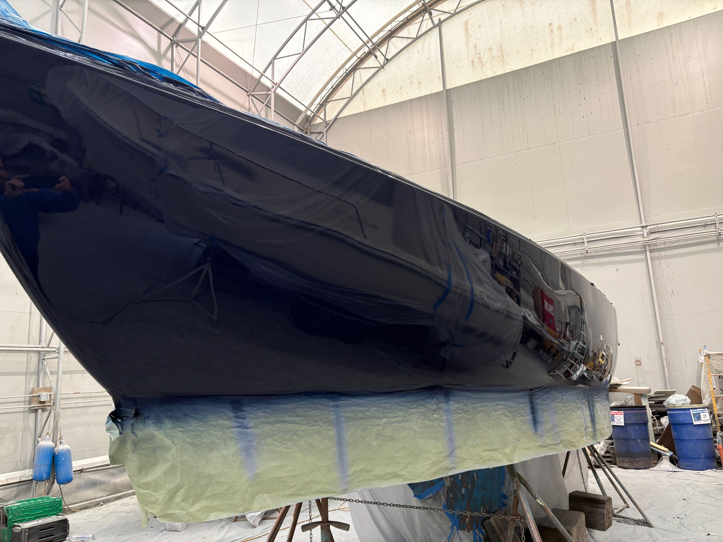 Dark hull masked at the waterline before coating, Essential Shipyard