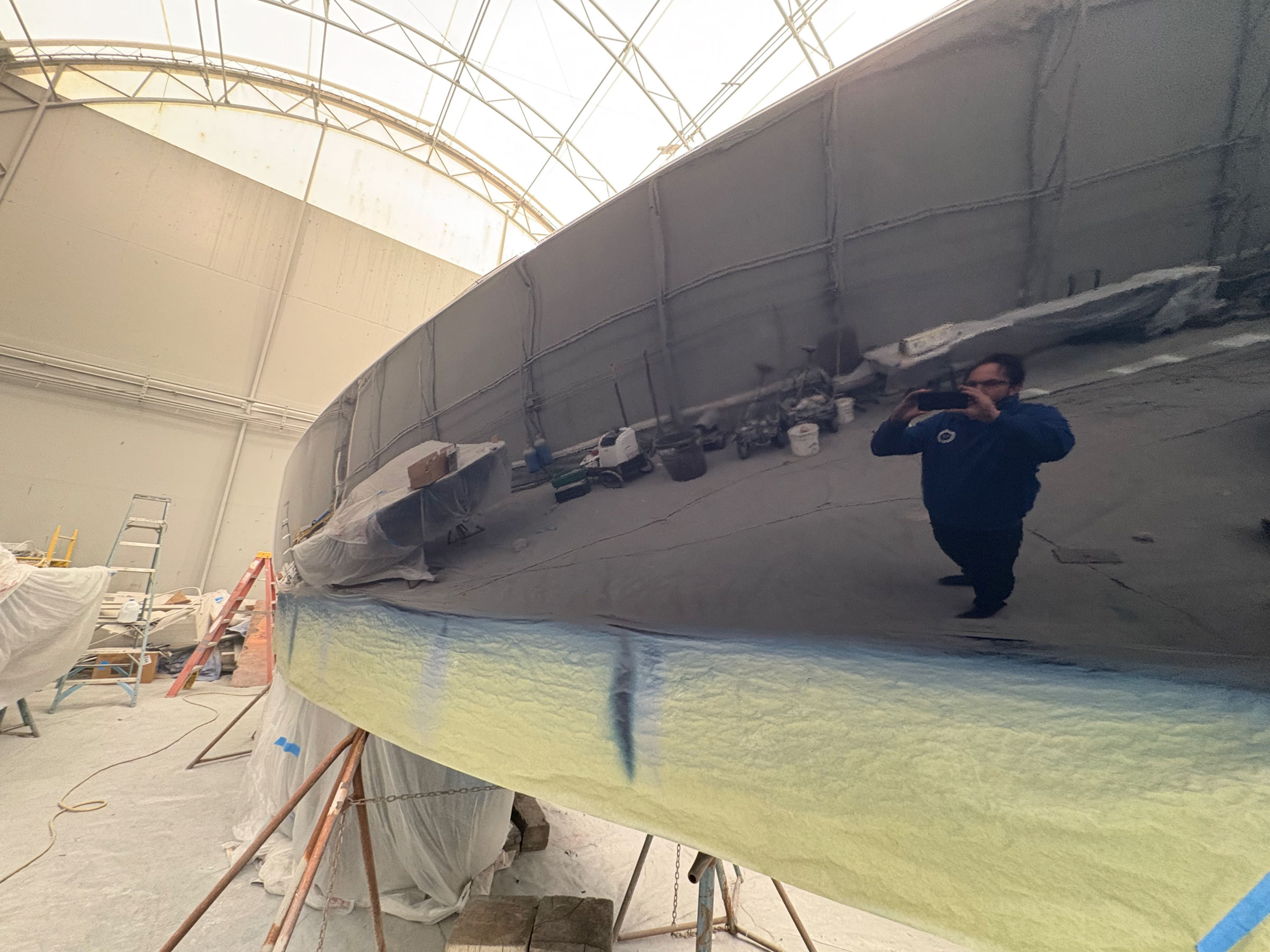 Fiberglass hull faired and sanded in the covered bay, Essential Shipyard