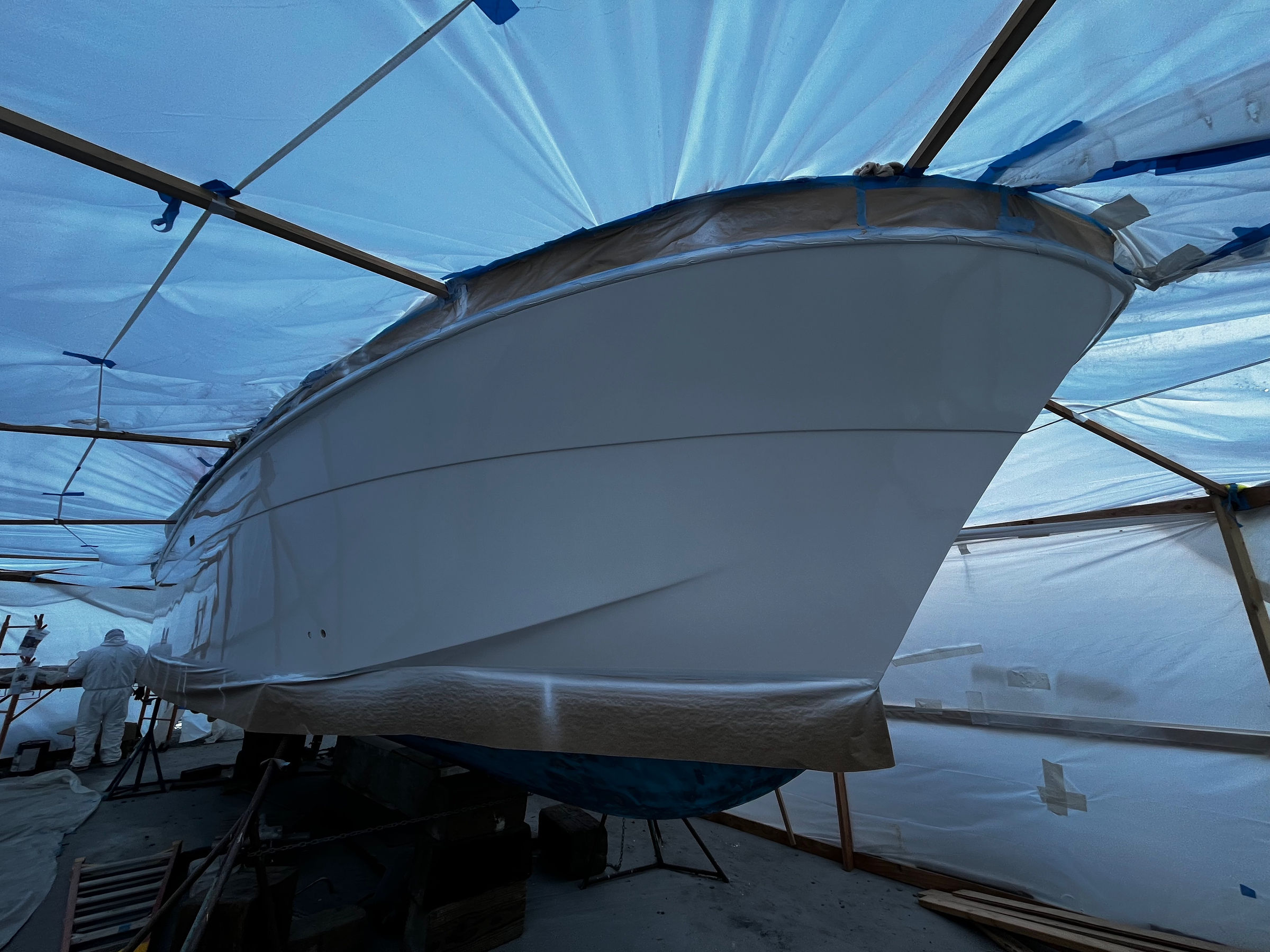 Bow of a vessel under containment for paint at Essential Shipyard