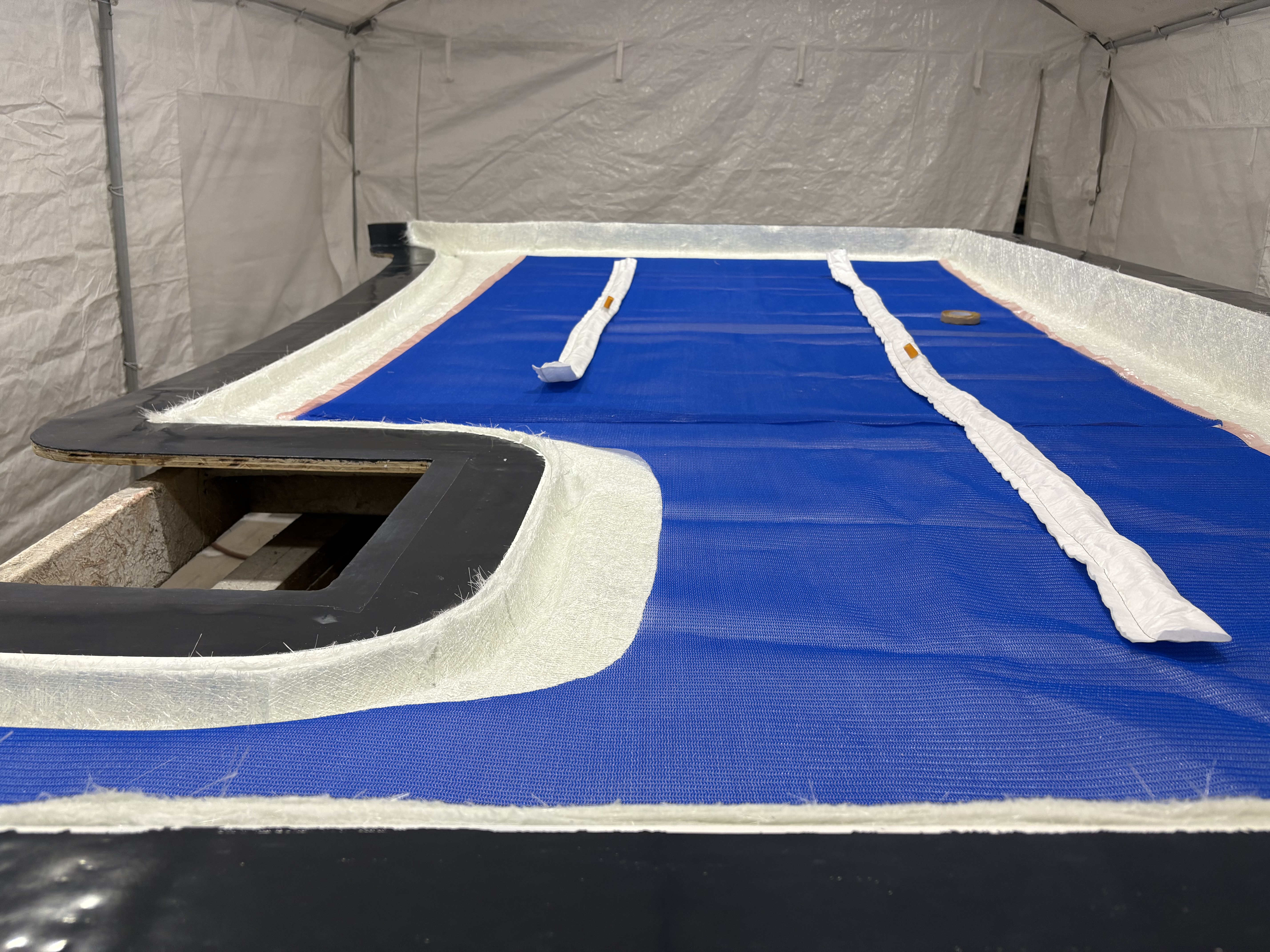 Deck panel with the non-skid area masked and new glass laid, Essential Shipyard