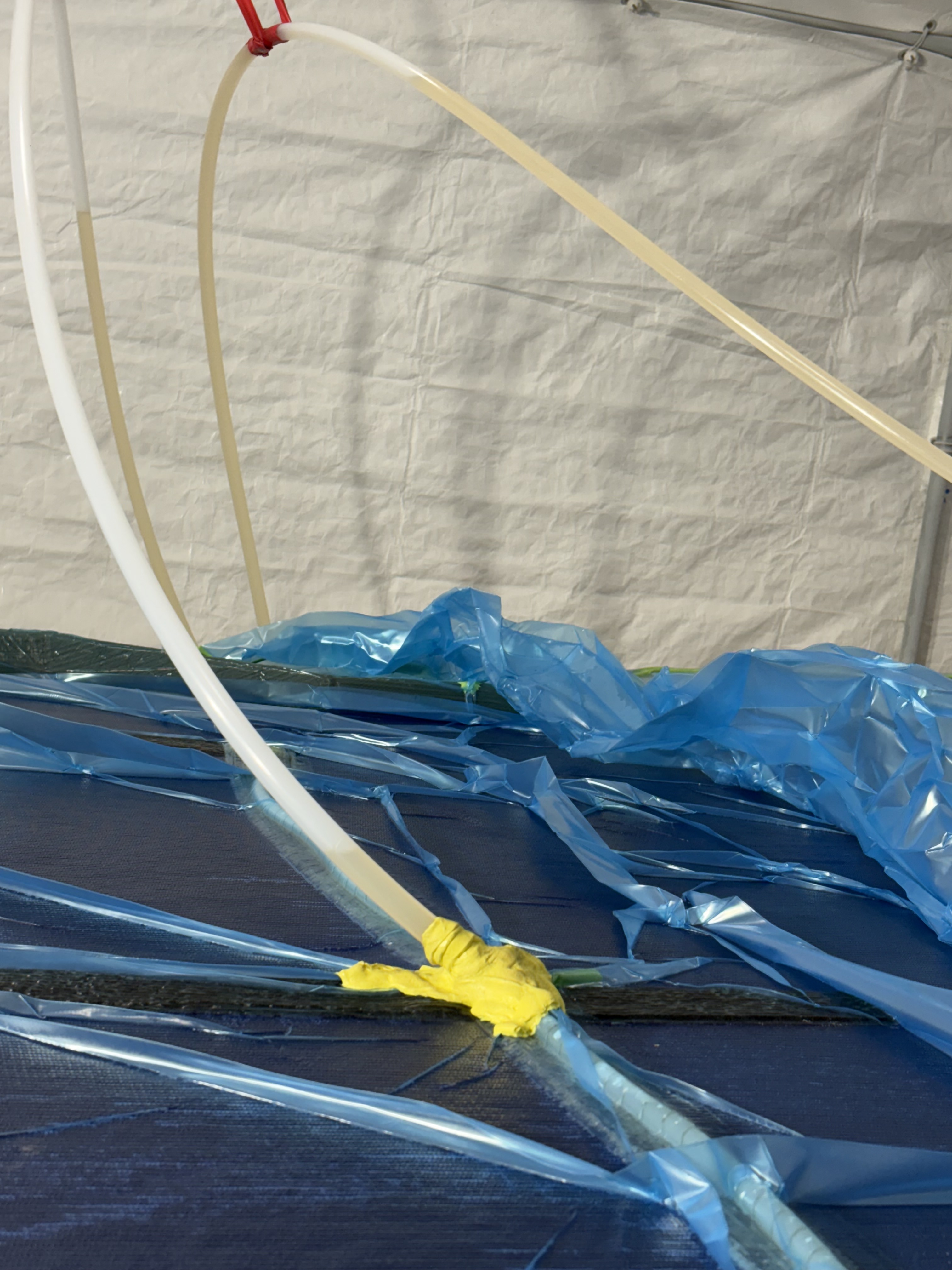Resin feed lines and clamps on a vacuum bag, Essential Shipyard