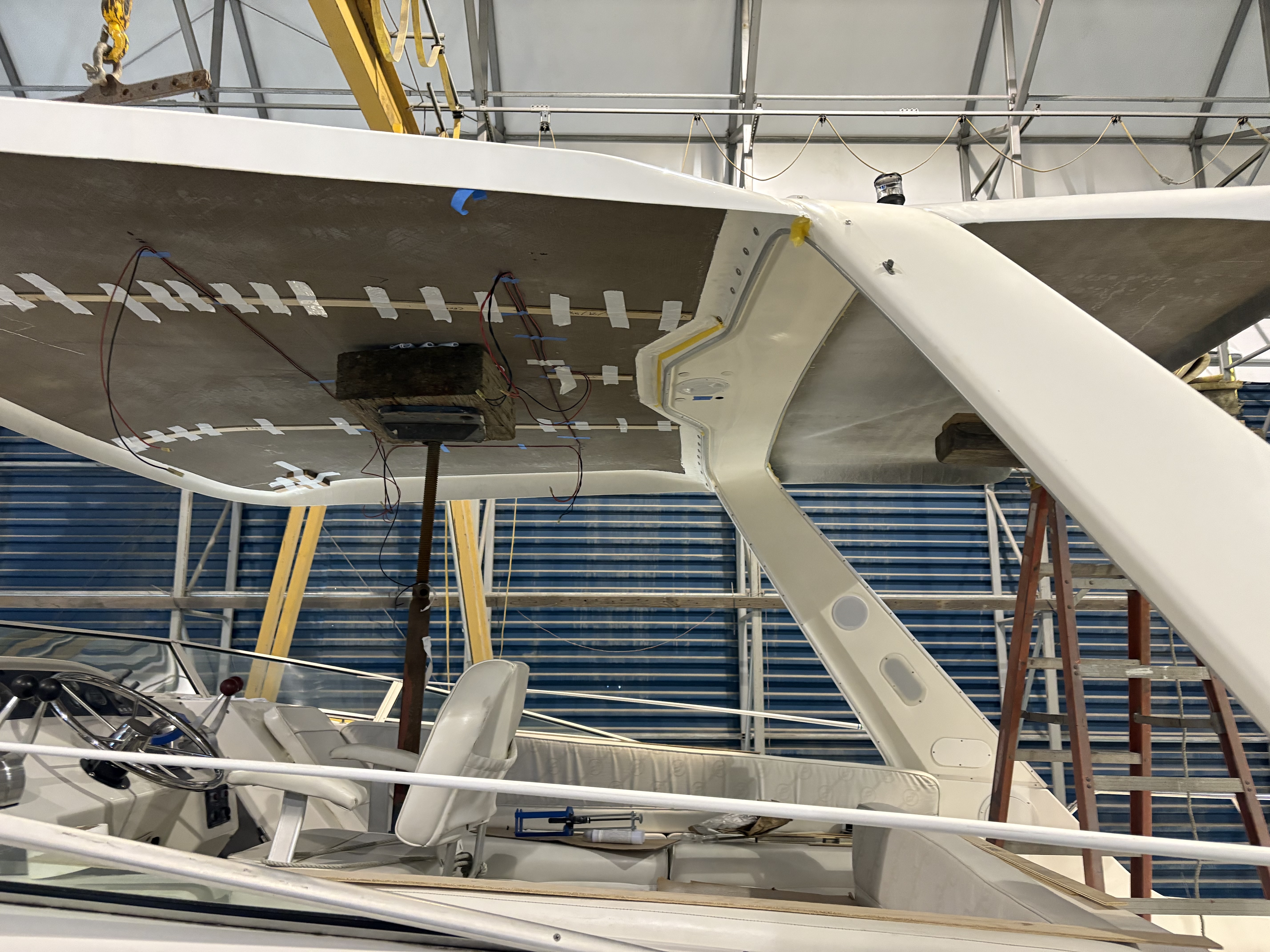 Underside of an installed hardtop showing the mounting struts and wiring