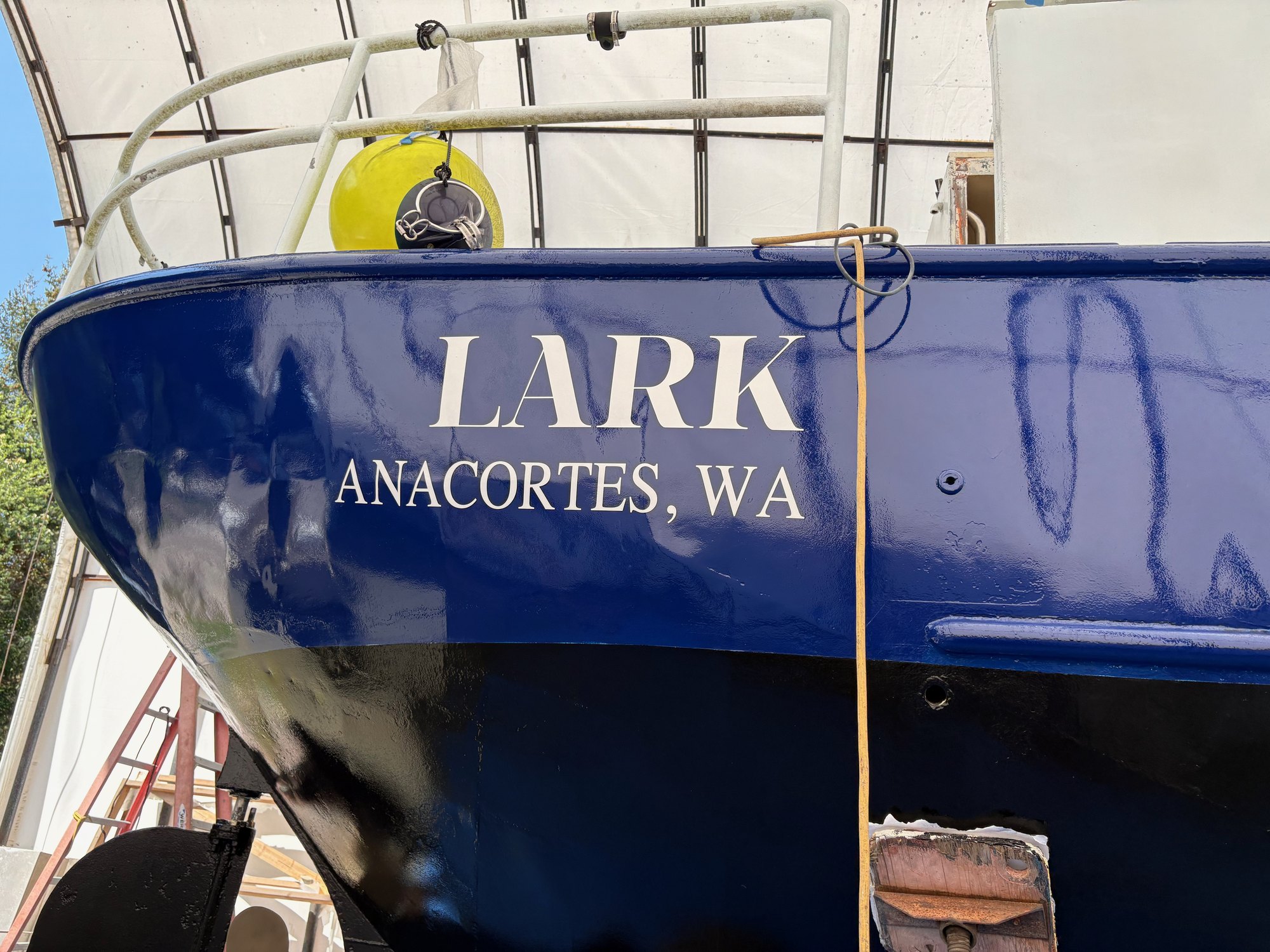 A metal hull refinished, gloss showing along the side.