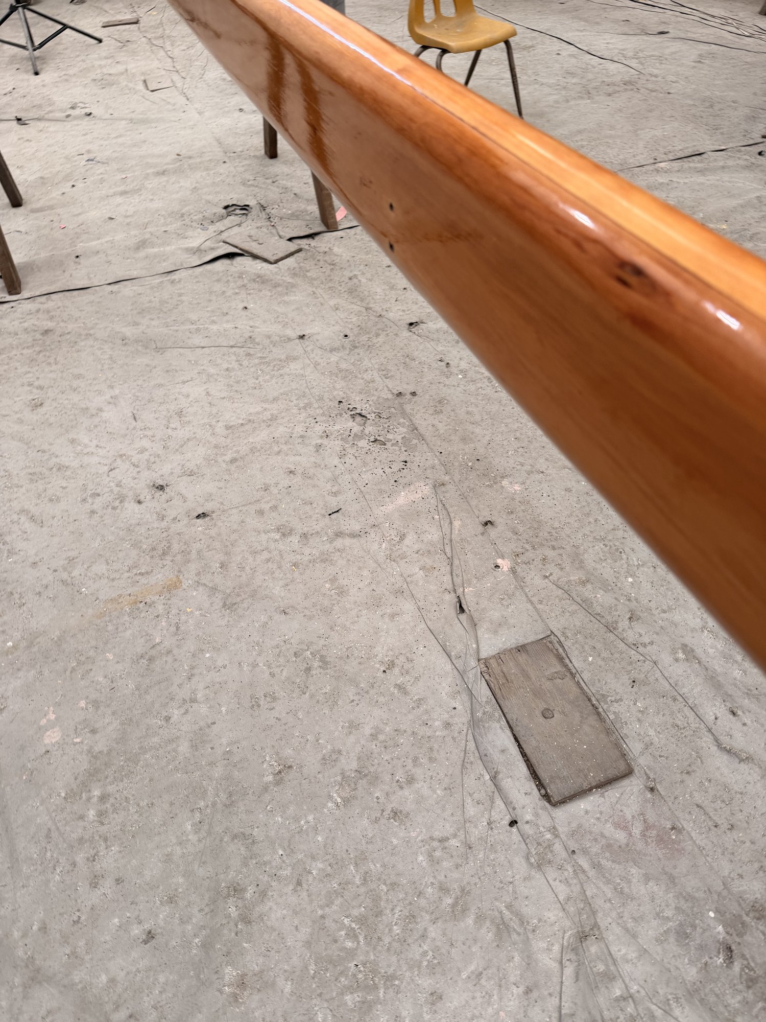 Clear finish building along the length of the repaired spar.
